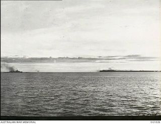 NEAR AITAPE, NORTH EAST NEW GUINEA. 1944-04-22. SHELLING AND DIVE BOMBING WHICH PRECEDED THE AITAPE LANDING AS VIEWED ACROSS THE WATER BY RAAF ENGINEERS ON THE DECK OF THEIR LANDING SHIP, TANK ..