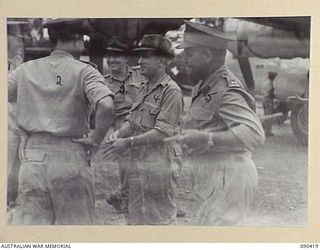 TOROKINA, BOUGAINVILLE. 1945-04-09. THE ACTING MINISTER FOR THE ARMY, SENATOR J.M. FRASER (4), AND SENIOR OFFICERS IN FRONT OF A RAAF LIBERATOR AIRCRAFT SHORTLY AFTER HIS ARRIVAL AT PIVA AIRSTRIP ..