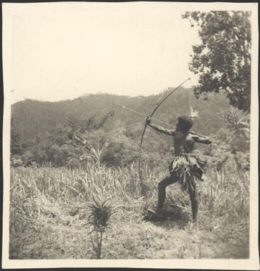 Man firing a bow and arrow, New Guinea, ca. 1936, 1 / Sarah Chinnery