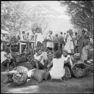 Women seated with baskets of produce, Boong, native markets, Rabaul, New Guinea, ca. 1936 / Sarah Chinnery