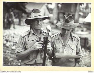 JACQUINOT BAY, NEW BRITAIN. 1945-03-11. VX112219 MAJOR C.R. AITKEN (1) AND NX161759 LIEUTENANT N.J. SPRING- THORPE (2), 19TH BASE ORDNANCE DEPOT, AT THE MICROPHONE DURING THE AQUATIC CARNIVAL OF ..