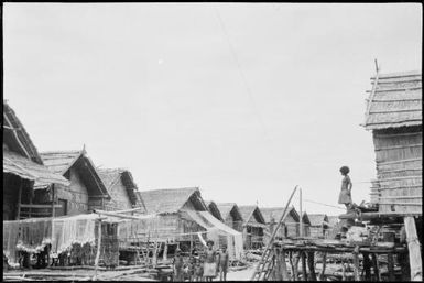 Child on a verandah and a group of children below, Hanuabada, Papua, ca. 1923 / Sarah Chinnery