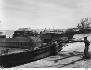 BORAM, NEW GUINEA. 1945-10-19. BARGES OF 43 LANDING CRAFT COMPANY ON THE BEACH. A CAPTURED JAPANESE BARGE IS IN FOREGROUND