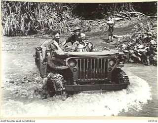 1943-09-20. NEW GUINEA. BUSO RIVER - LAE AREA. A JEEP FORDS A TRIBUTARY OF THE BUSO RIVER. (NEGATIVE BY H. DICK)