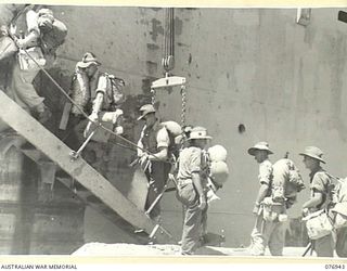 LAE, NEW GUINEA. 1944-11-10. TROOPS OF THE 5TH SUB AREA EMBARKING ABOARD THE AMERICAN LIBERTY SHIP, "J.STERLING MORTON" FOR JACQUINOT BAY