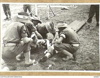 NEW GUINEA. 1943-11-20. STRETCHER BEARER CHAMPIONSHIP AT THE CHAMPIONSHIP SPORTS MEETING OF THE 18TH AUSTRALIAN INFANTRY BRIGADE, HELD TO CELEBRATE THE FOURTH ANNIVERSARY OF THE FORMATION OF THE ..
