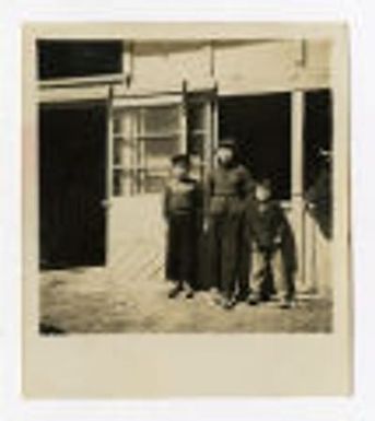 Three children in front of building