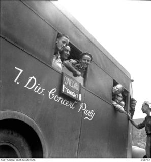 POMPOM VALLEY, NEW GUINEA. 1943-10-26. MEMBERS OF THE 7TH AUSTRALIAN DIVISION CONCERT PARTY ON BOARD THEIR BUS. LEFT TO RIGHT:- NX68675 PRIVATE (PTE) N. J. CHYNOWETH; VX81251 PTE T. R. CLEMENS; ..