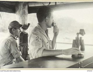 FINSCHHAFEN, NEW GUINEA. 1944-09-20. UNITED STATES ARMY AIR FORCE PERSONNEL IN THE CONTROL TOWER AT THE AIRFIELD BUSILY OCCUPIED AS PLANES LAND AND TAKEN OFF IN QUICK SUCCESSION