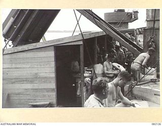 AT SEA. 1944-10-27. TROOPS OF HEADQUARTERS FIRST ARMY AT A MESS PARADE ABOARD THE LIBERTY SHIP SS JAMES OLIVER DURING THEIR MOVEMENT TO NEW GUINEA