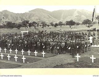 DUMPU, NEW GUINEA. 1944-02-06. VX39632 CHAPLAIN F.J. HARTLEY (METHODIST) (2) AND SX1476 CHAPLAIN D.L. REDDING, (CHURCH OF ENGLAND) (1) JOINTLY CONDUCTING THE DEDICATION SERVICE AT THE DUMPU WAR ..