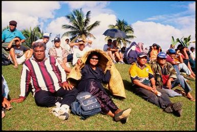 People sitting on a grassy slope, Tonga