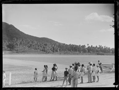 Group of unidentified people, including locals at Rarotonga airfield, Cook Islands