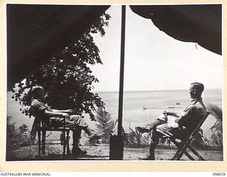 RABAUL, NEW BRITAIN. 1945-11-19. OFFICERS OF 52 TRANSPORT PLATOON, AUSTRALIAN ARMY SERVICE CORPS, OUTSIDE THEIR TENT ON THE SHORE OF TALILI BAY