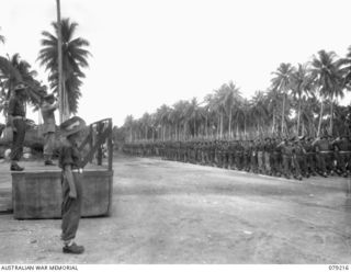 AITAPE, NEW GUINEA. 1945-02-23. VX17 MAJOR GENERAL J.E.S. STEVENS, DSO, ED, GENERAL OFFICER COMMANDING 6TH DIVISION TAKES THE SALUTE AS THE 2/8TH INFANTRY BATTALION MARCHES PAST THE SALUTING BASE ..