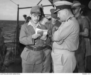 THE SOLOMON ISLANDS, 1945-08-19. AN ENVOY OF LIEUTENANT GENERAL MASATANE KANDA, COMMANDER JAPANESE XVII ARMY, CONVEYS A MESSAGE FROM THE GENERAL TO AUSTRALIAN SERVICEMEN ON BOARD HMAS LITHGOW OFF ..
