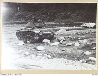 TOROKINA, BOUGAINVILLE, 1945-08-14. AN M24 LIGHT TANK FORDING AND NEGOTIATING BOULDERS IN A RIVER BED DURING ACTIVITIES OF THE BRITISH WAR OFFICE TRIALS TEAM (TANKS)