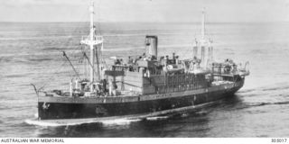 An aerial port bow view of the 2,608 ton Netherlands cargo steamer Both.  A 12 pounder AA gun is mounted on the stern with light AA guns in the bridge wings. The Both helped transport Australian ..