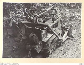 A BULLDOZER AT WORK, BREAKING DOWN THE ESCARPMENT SOUTH OF THE HONGORAI RIVER, TO ALLOW TRANSPORT THROUGH WITH SUPPLIES AND AMMUNITION, DURING THE ADVANCE OF 57/60 INFANTRY BATTALION ALONG COMMANDO ..