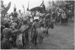 Pig festival, pig sacrifice, Tsembaga: women and children watch decorated men dance