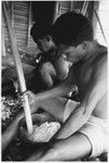 Men pounding taro and coconut pudding