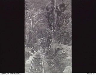 BOUGAINVILLE, 1945. A TWO FOOT GAUGE RAILWAY BUILT BY 23RD FIELD COMPANY AUSTRALIAN ENGINEERS TO SUPPLY TROOPS ON THE NUMA NUMA TRAIL. IT ROSE 894 FEET UP BARGES' HILL. THIS PHOTOGRAPH IS TAKEN ..