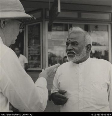 Men speaking outside of shop