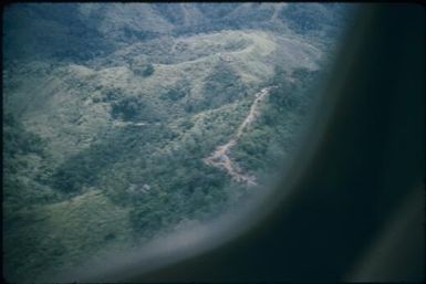 Maprik foothills showing road : Wewak-Maprik, Papua New Guinea,1959 / Terence and Margaret Spencer