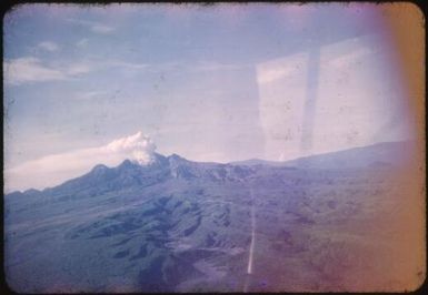 Aerial view of the volcano on the horizon, Mt. Lamington, Papua New Guinea, 1951 / Albert Speer