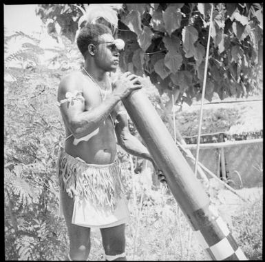 Man with a wooden trumpet, New Guinea, ca. 1936 / Sarah Chinnery