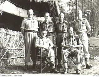 KILIGIA, NEW GUINEA, 1944-03-16. THE GENERAL OFFICER COMMANDING HEADQUARTERS, 5TH DIVISION, VX27 MAJOR-GENERAL A.H. RAMSAY, CBE, DSO, ED, (1), WITH HIS SENIOR STAFF. IDENTIFIED PERSONNEL ARE: ..