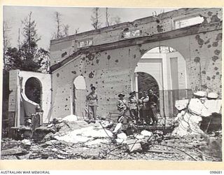 RABAUL, NEW BRITAIN. 1945-11-04. AUSTRALIAN ARMY MEDICAL WOMEN'S SERVICE PERSONNEL FROM 118 GENERAL HOSPITAL VIEW THE WRECKAGE OF THE ONCE FAMOUS NEW GUINEA CLUB AND SEE FOR THE FIRST TIME THE ..