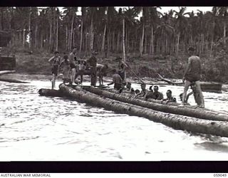 BUMI RIVER, NEW GUINEA. 1943-10-19. ENGINEERS OF THE 2/3RD AUSTRALIAN FIELD COMPANY, ROYAL AUSTRALIAN ENGINEERS, CONSTRUCTING A NEW BRIDGE OVER THE RIVER TO REPLACE THE ONE WHICH WAS WASHED AWAY ..