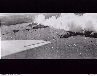 NADZAB, NEW GUINEA. 1943-09-05. UNITED STATES C47 AIRCRAFT FLYING IN OVER THE NADZAB DROP ZONE BEHIND A SMOKE SCREEN LAID DOWN BY A20 (BOSTON) AIRCRAFT DURING THE AIRBORNE ASSAULT DELIVERING MEN OF ..