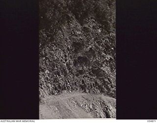 BULLDOG-WAU ROAD, NEW GUINEA, 1943-07-20. SINDEL SCAR, NAMED AFTER NX110933 MAJOR H. G. SINDEL, OFFICER COMMANDING 9TH AUSTRALIAN FIELD COMPANY. ALL THIS ROCK WAS CUT BY HAND