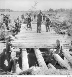 1942-12-05. BUNA. ALLIED TROOPS BUILD A BRIDGE ACROSS SEMINI CREEK. TANKS RACED ACROSS THIS BRIDGE IN THE ATTACK ON THE MAIN BUNA AIRSTRIP. (NEGATIVE BY G. SILK)