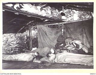 KAHILI, BOUGAINVILLE. 1945-09-10. SICK JAPANESE SOLDIERS LYING IN ONE OF THEIR HUTS. THE BUIN LIAISON PARTY FROM HEADQUARTERS 2 CORPS IS ORGANISING SURRENDER DETAILS IN THE AREA
