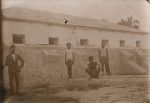 Group in an empty water tank, Cila. Church in the background