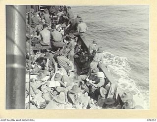 SIPAAI, BOUGAINVILLE ISLAND. 1945-01-07. TROOPS OF THE 31/51ST INFANTRY BATTALION RELAXING ABOARD THE AV1361 "POOLTA" AS SHE APPROACHES THE MOUTH OF THE KAIKARA RIVER WHERE THE UNIT IS MAKING A ..