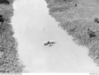 Kerawari River, Wewak area, New Guinea, 1945-06. Aerial view of a Supermarine Walrus amphibian aircraft of No. 111 Air Sea Rescue Flight RAAF at rest on the Kerawari River, during the rescue of the ..