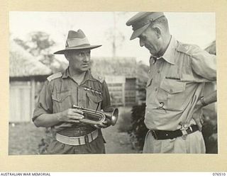 LAE, NEW GUINEA. 1944-10-18. NX201 MAJOR H.E. GALE, MBE, CAMP COMMANDANT, 2ND AUSTRALIAN CORPS (1) SHOWING NGX350 MAJOR E.W. JENYNS, DEPUTY ASSISTANT DIRECTOR OF NATIVE LABOUR AND OFFICER IN ..