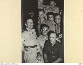 PORT MORESBY, PAPUA, 1944-02-20. MEMBERS OF THE STAFF OF "9PA" BROADCASTING STATION, A NEWLY OPENED AUSTRALIAN BROADCASTING COMMISSION STATION, MANNED BY BOTH AUSTRALIANS AND AMERICANS, A POPULAR ..