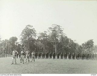 LAE, NEW GUINEA. 1944-09-09. VX13 LIEUTENANT-GENERAL S. G. SAVIGE CB CBE DSO MC ED GOC, NEW GUINEA FORCE (1) ACCOMPANIED BY NGX302 CAPTAIN R. H. HICKS, OFFICER-IN-CHARGE, ROYAL PAPUAN CONSTABULARY, ..