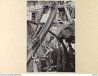 MIOS WUNDI, DUTCH NEW GUINEA. 1944-11-12. HMAS STAWELL REFUELLING IN HARBOUR FROM USS VICTORIA, USN. THE PIPELINE IN USE IS SEEN IN THE FOREGROUND