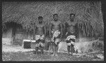 Three men in front of a house