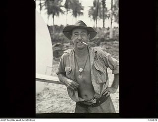 MOMOTE, LOS NEGROS ISLAND, ADMIRALTY ISLANDS. 1944-03-18. CORPORAL P. M. "SCOTTY" RODGER, WILLOUGHBY, NSW, A FLIGHT RIGGER WITH NO. 76 (KITTYHAWK) SQUADRON RAAF, WITH CIGARETTE IN HIS MOUTH, HAS ..