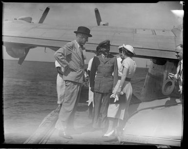 Tasman Empire Airways Ltd, courtesy flight, Governor of Fiji, Sir Leslie [Brian?], Freeston, his wife, and the [flying boat captain?], Suva, Fiji,