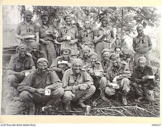 KUNAI RIDGE, NEW GUINEA, 1945-07-11. MEMBERS OF 9 PLATOON, A COMPANY, 2/5TH INFANTRY BATTALION, HAVING A BREW BEFORE SETTING OUT TO ATTACK KULAURU MISSION. THEIR FACES HAVE ALL BEEN BLACKENED WITH ..