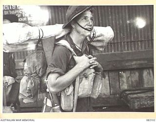 CAIRNS, QLD. 1944-10-28. SAPPER J. CLAPP, 2/2 FIELD COMPANY, ROYAL AUSTRALIAN ENGINEERS, AWAITS EMBARKATION DURING MOVEMENT OF ELEMENTS OF 6 DIVISION TO NEW GUINEA
