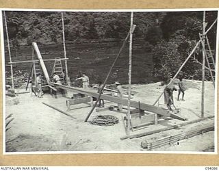 BALASANA, NEW GUINEA, 1943-07-06. KEEL BEING SHAPED FOR A NEW VESSEL AT THE SHIPYARDS OF THE 1ST AUSTRALIAN WATER TRANSPORT GROUP (SMALL CRAFT) MAINTENANCE BASE